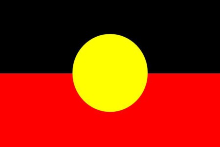 Aboriginal flag top half black, bottom half red and yellow circle in the centre