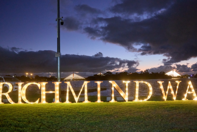 A light display on the grass in front of the ocean that saws Richmind WA