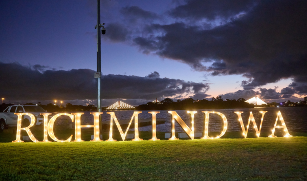 A light display on the grass in front of the ocean that saws Richmind WA
