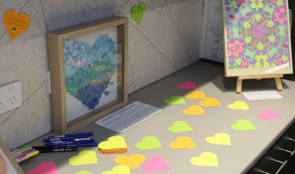 Paper of many different colours cut into the shape of hearts on a table