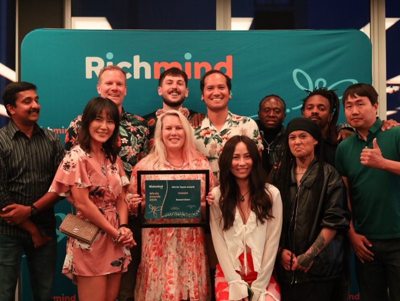 A group of people at the Metro Christmas party smiling and holding a Wirrin Team award