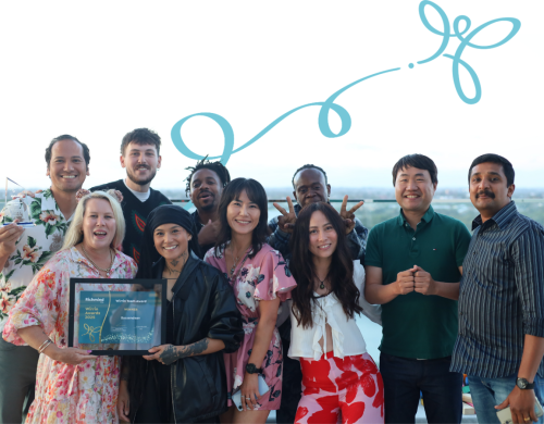 A group of people smiling together and holding a Wirrin Award