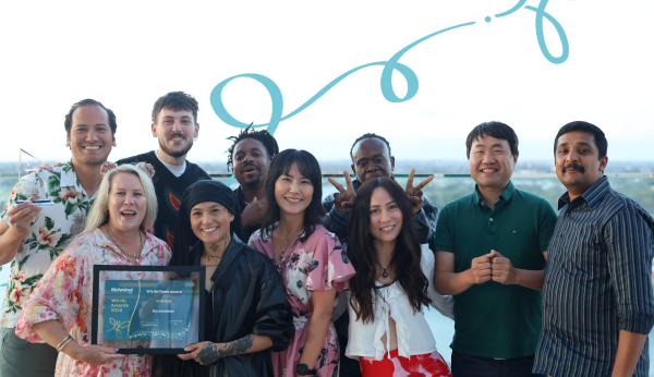 A group of people smiling together and holding a Wirrin Award