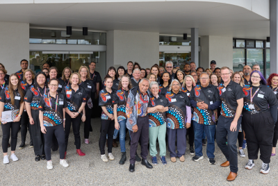 A group of people in polo shirts posing together for a photo