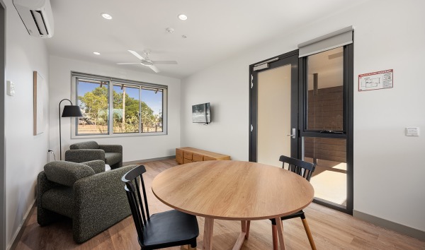 The inside of the Karratha Step Up/Step Down service building with a table and some chairs