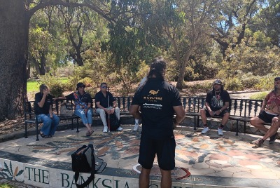 People sitting on benches in a circle for the MDW tour