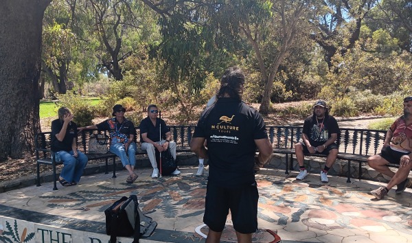 People sitting on benches in a circle for the MDW tour