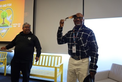 One of the men running the Red Dust training seminar touching a feather to his head