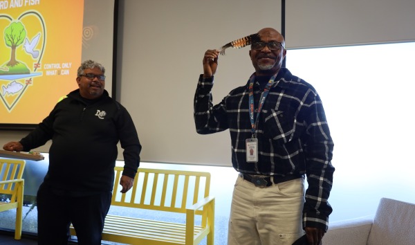 One of the men running the Red Dust training seminar touching a feather to his head