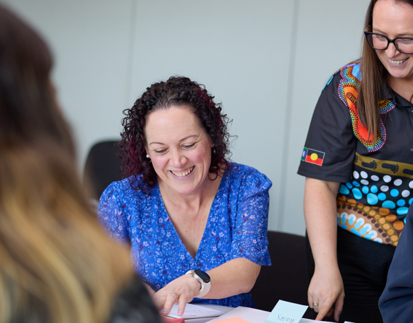 People smiling together at a mental health workshop