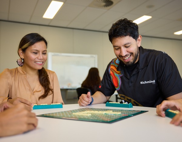 Richmind worker playing scrabble with a group of people